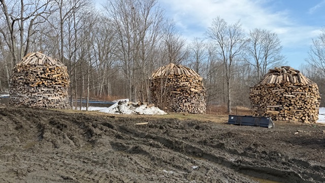 three large woodpiles