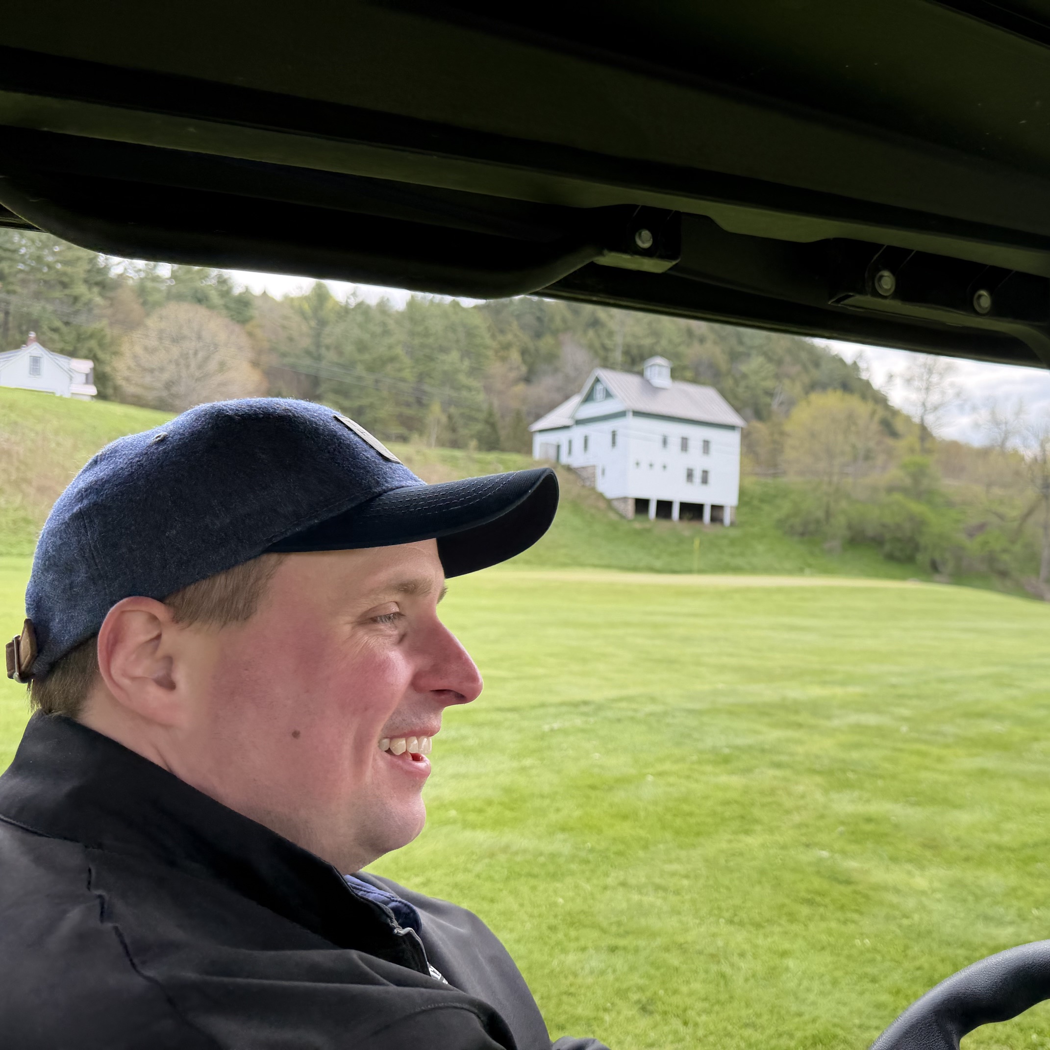 golfer in a golf cart smiling