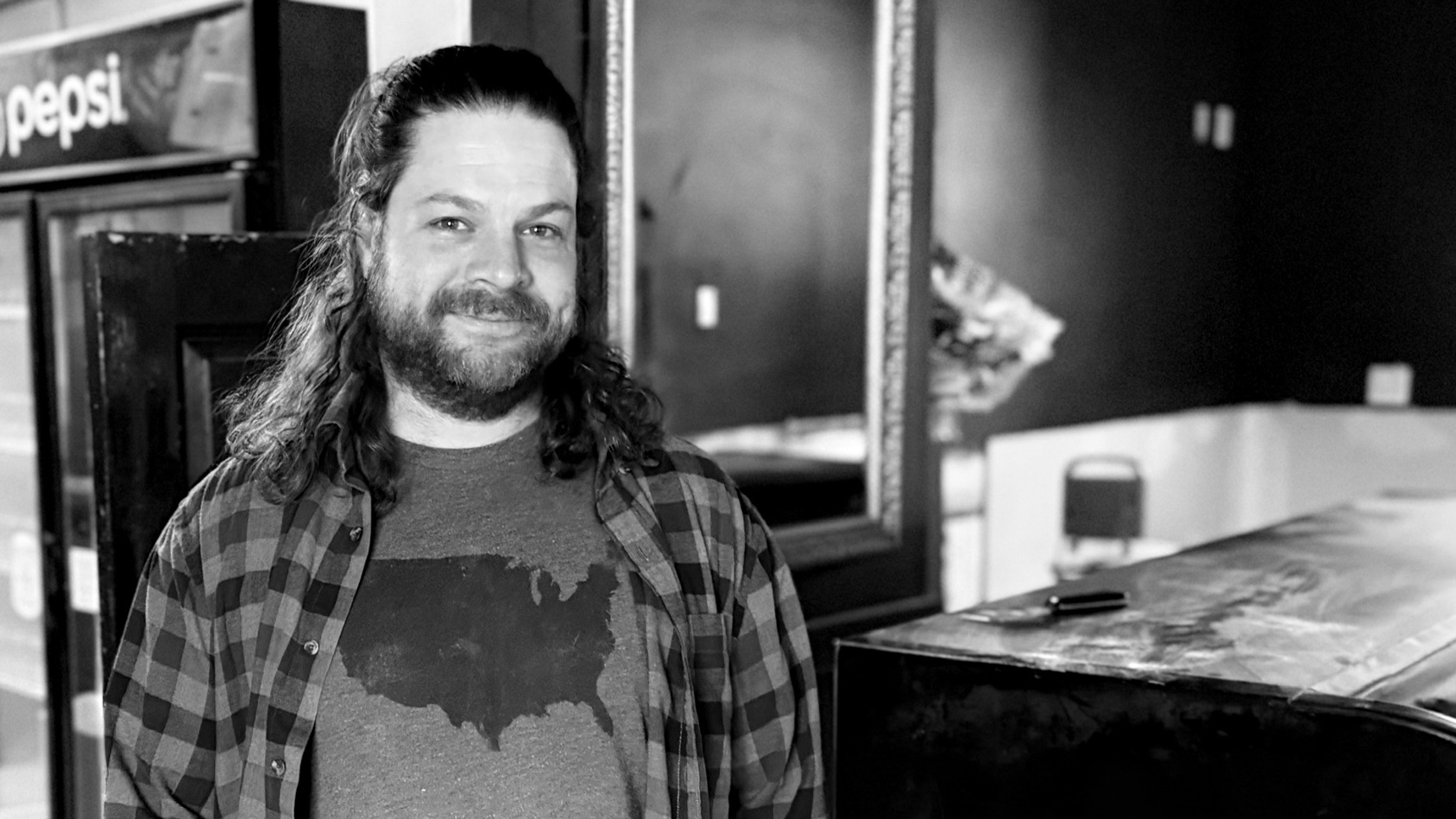 man w long hair smiling